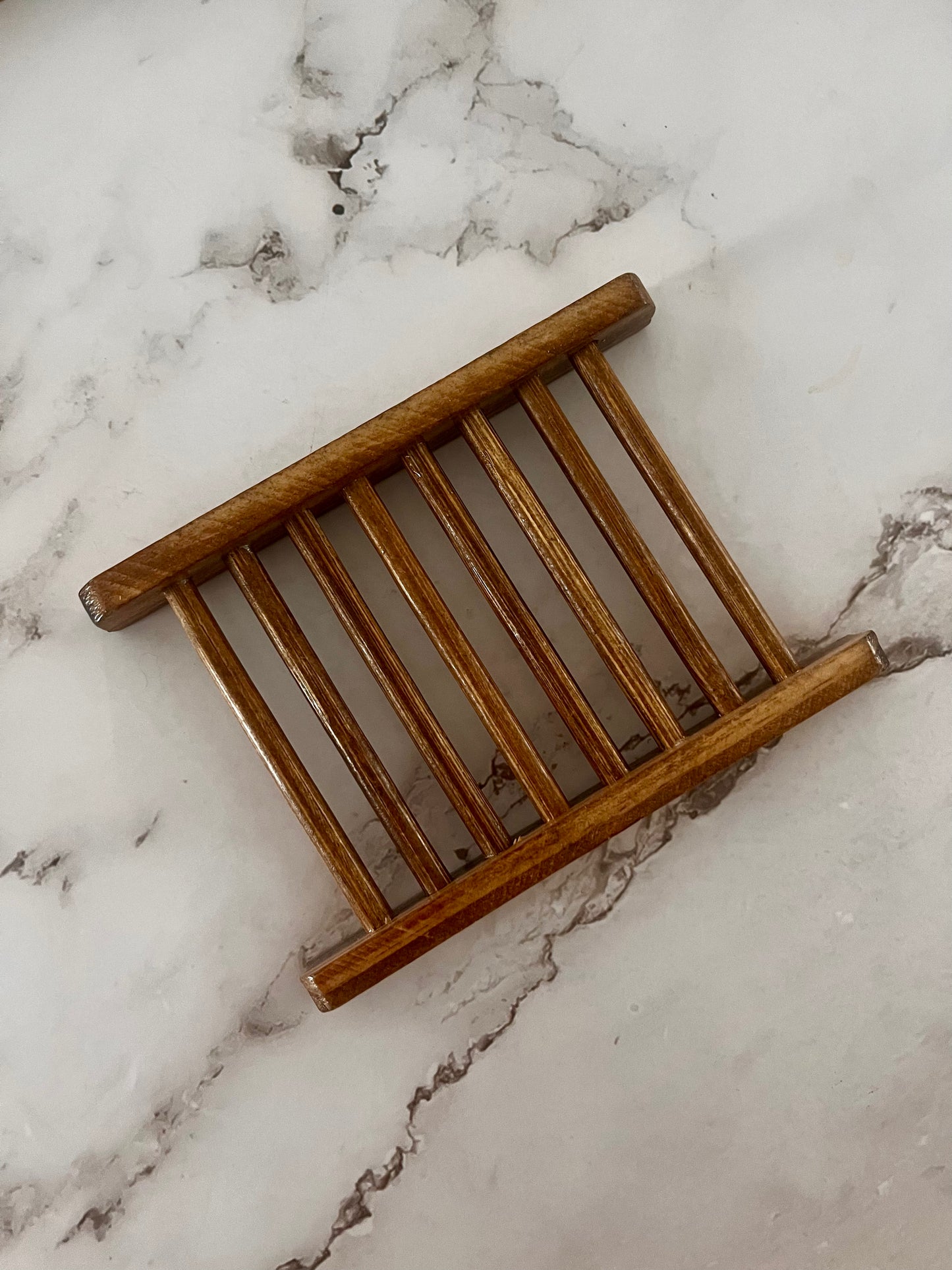 Wooden slatted coaster on a marble surface