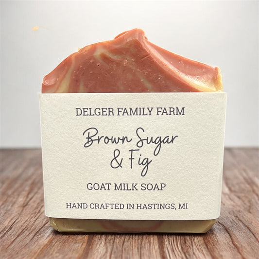 Bar of soap with a label on a wooden surface, featuring ‘Delger Family Farm' branding.