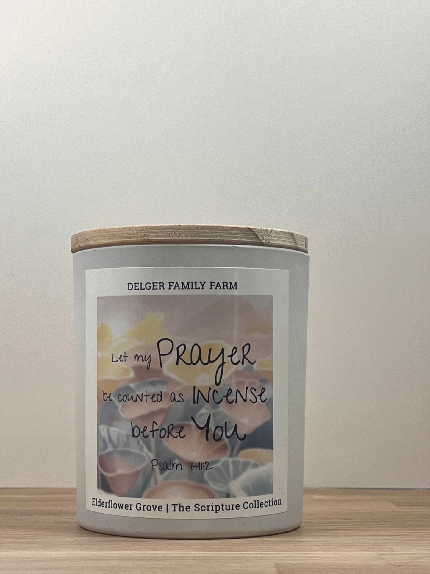 White candle sitting on wood 