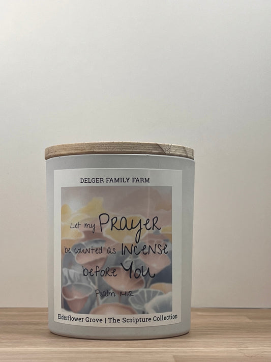 White candle sitting on wood 