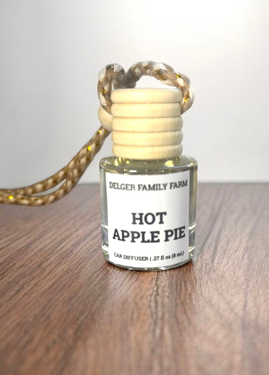 Diffuser with 'Hot Apple Pie' fragrance on a wooden surface