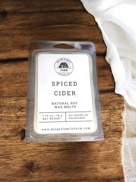 Spiced Cider wax melt packaging on a wooden surface with a white cloth