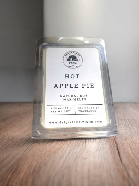 Hot Apple Pie wax melt packaging on a wooden surface with a gray background