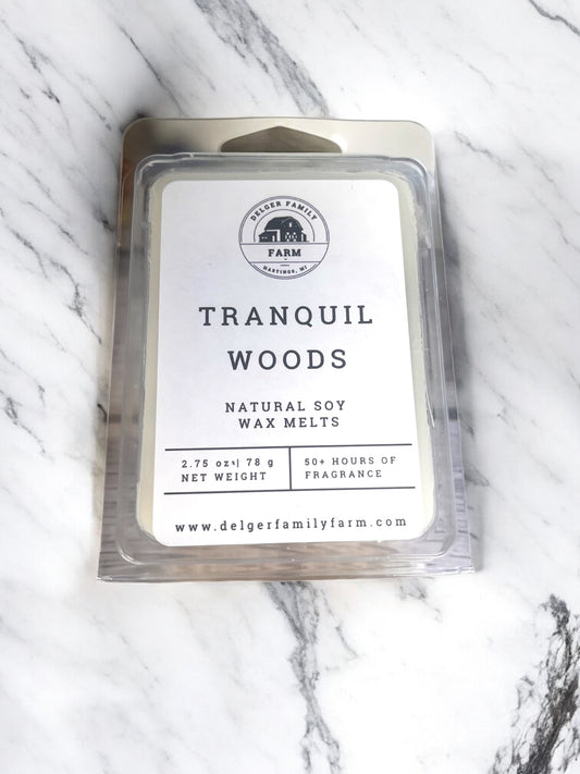 Pack of Tranquil Woods wax melts on a marble surface