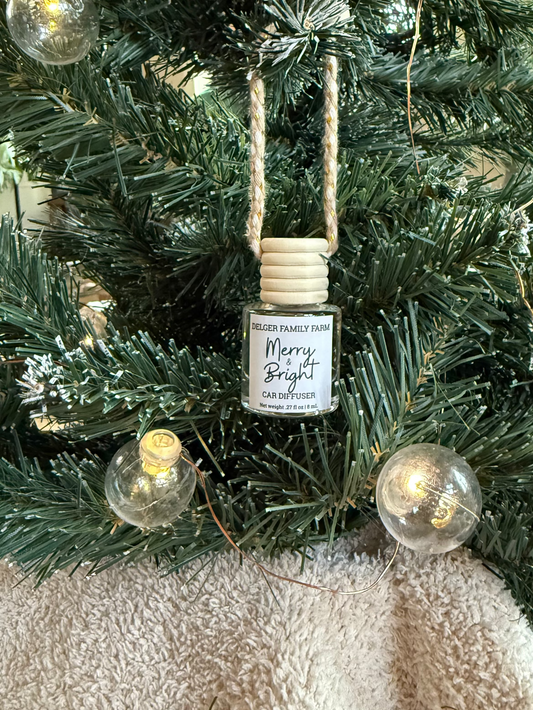 Decorative ornament with a small bottle labeled 'Merry & Bright' on a Christmas tree.