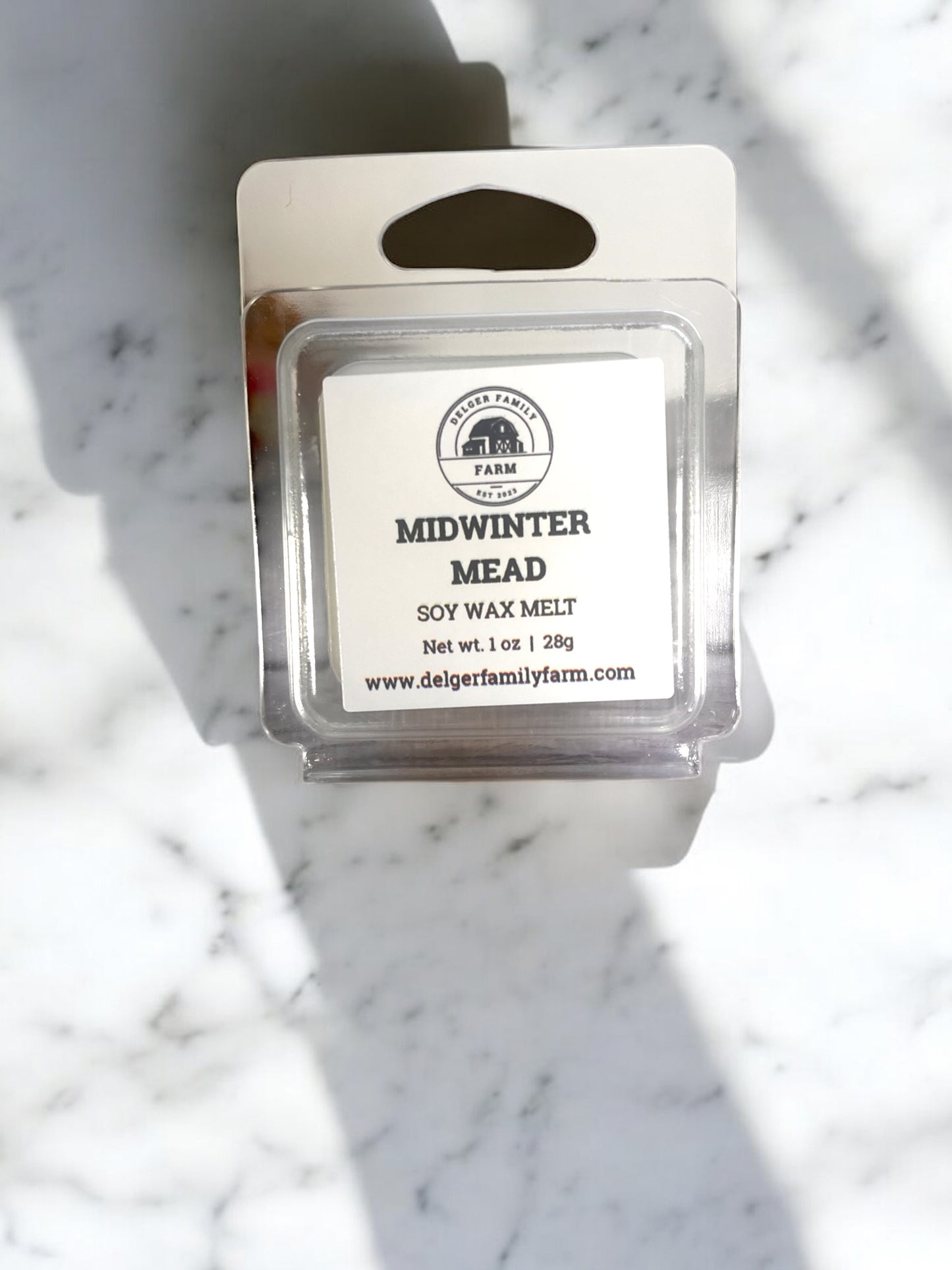 Soy wax melt packaging labeled 'Midwinter Mead' on a marble surface