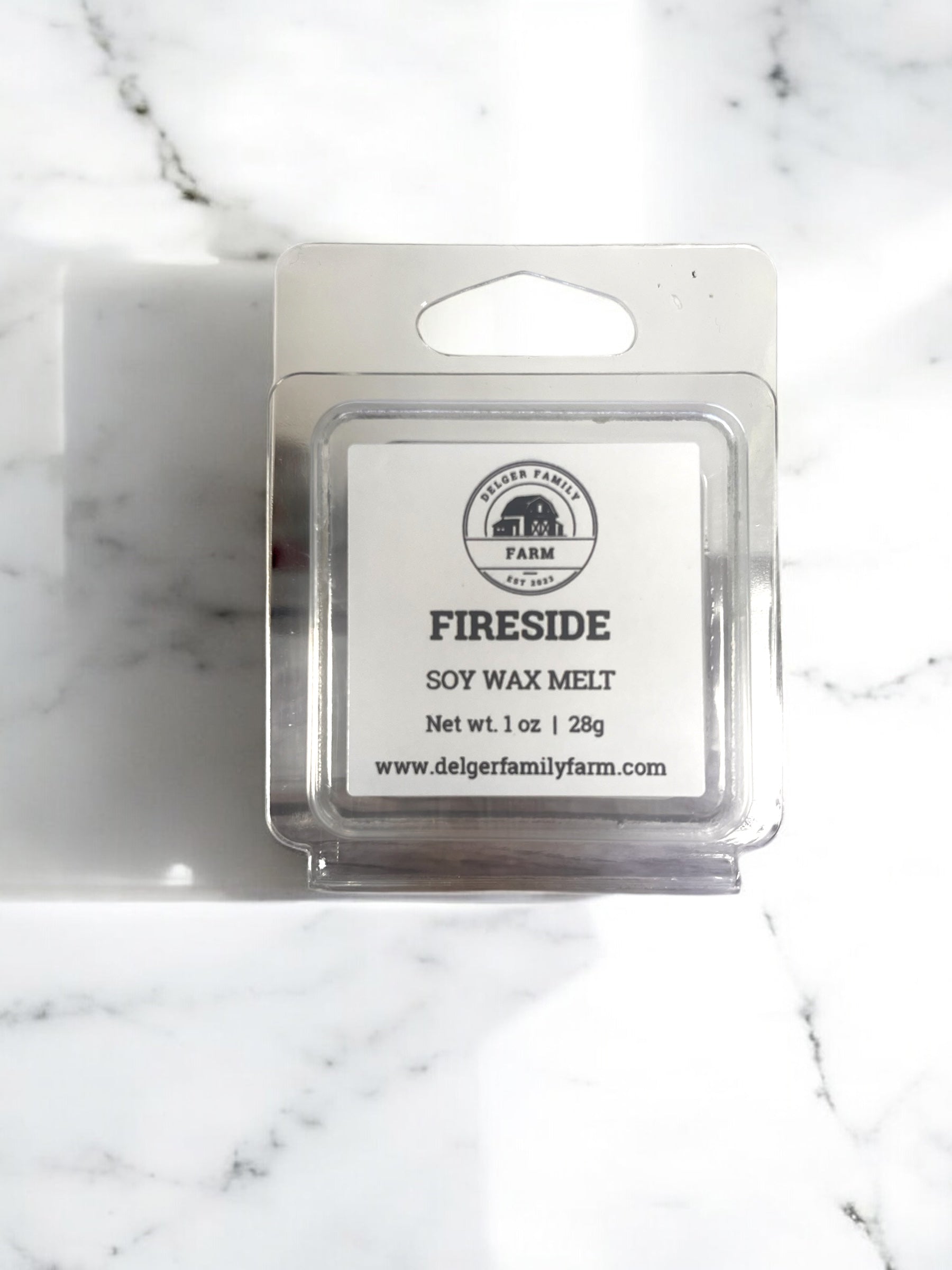 Soy wax melt package labeled 'Fireside' on a marble surface