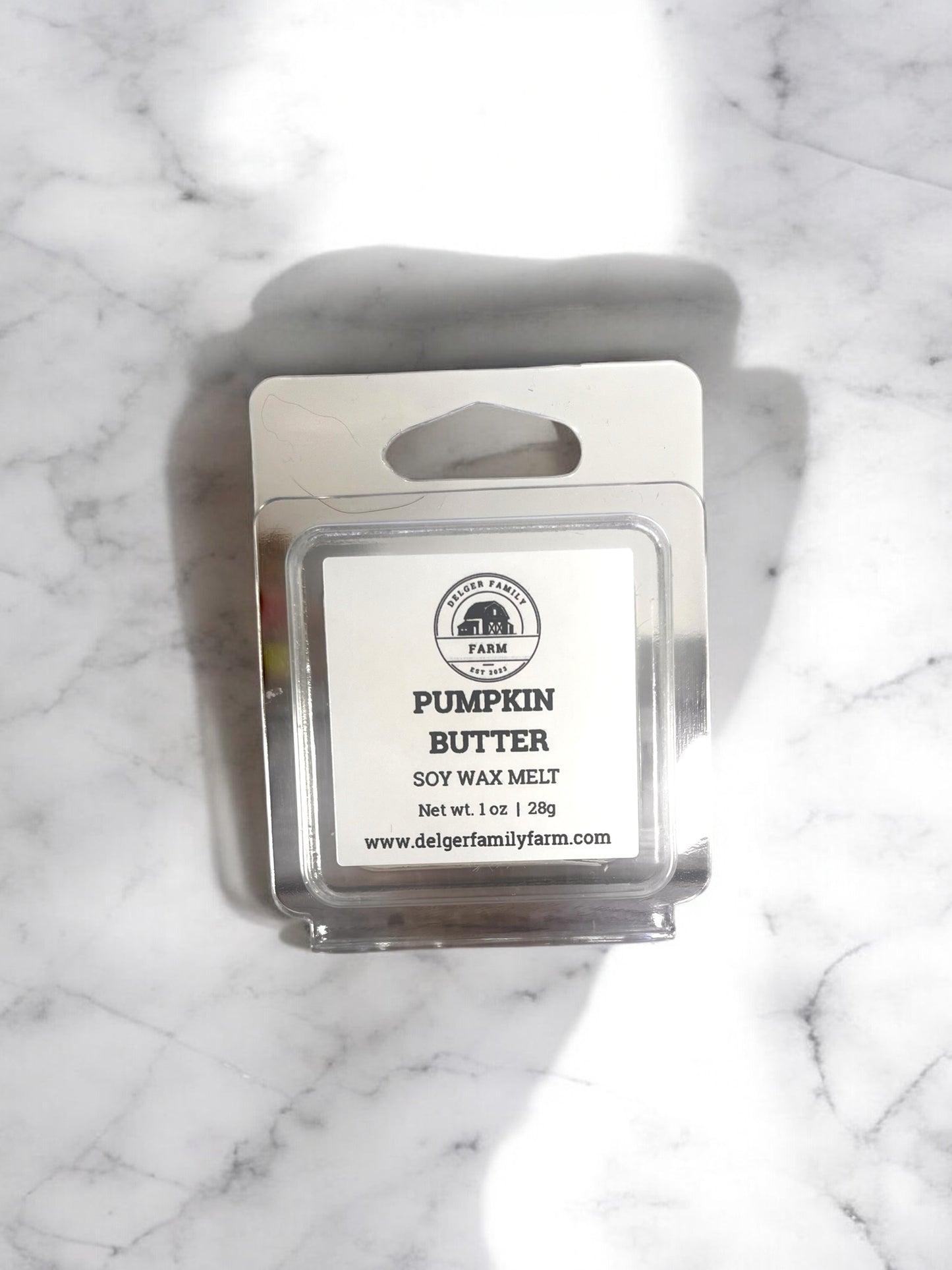 Pumpkin Butter wax melt packaging on a marble surface