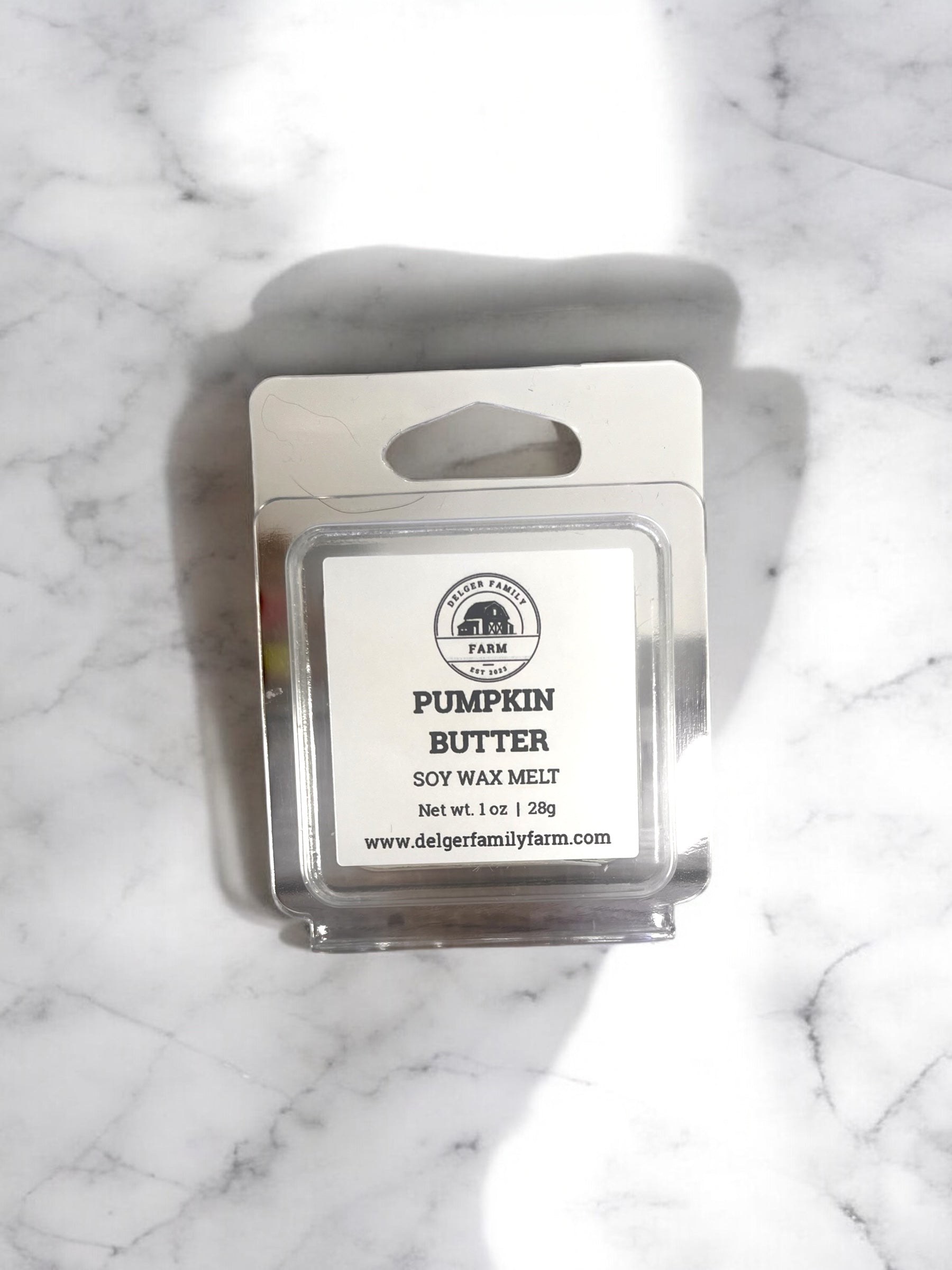 Pumpkin Butter wax melt packaging on a marble surface